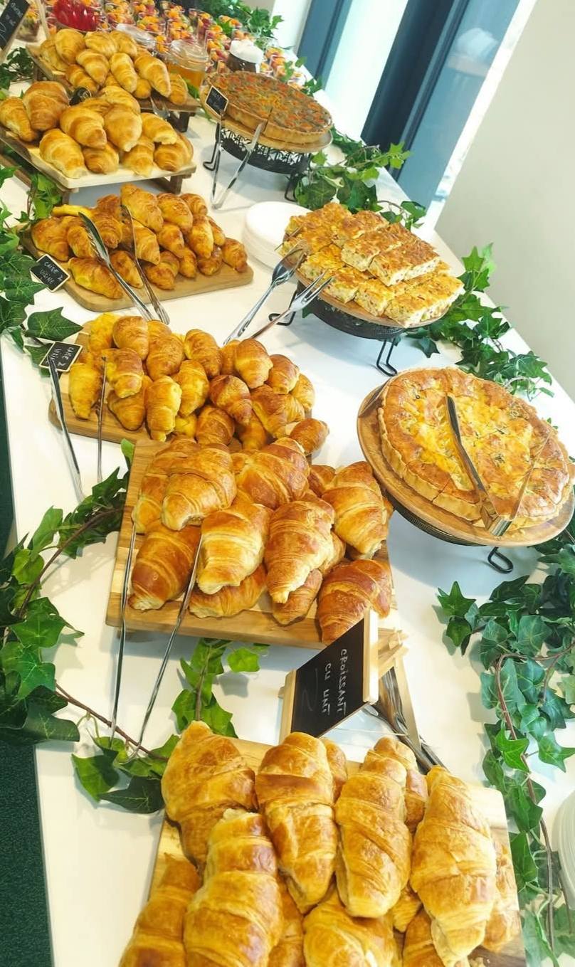 Bufet suedez bogat pentru evenimente corporate, cu o selecție variată de produse de patiserie proaspete, croissante, focaccia și quiche-uri.